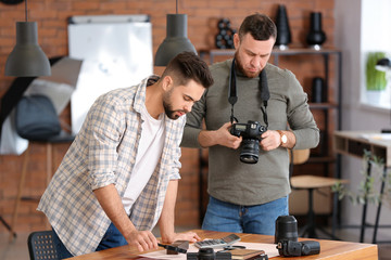 Wall Mural - Mentor teaching young photographer in studio