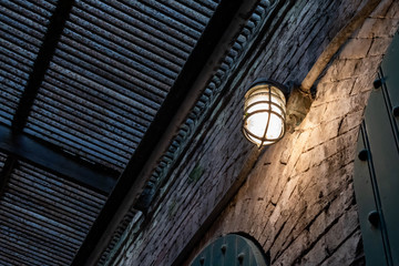 Vintage light on old brick wall good for backdrop and vintage background image