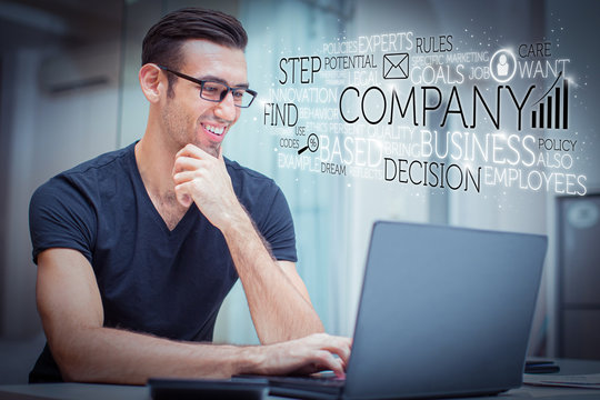 Happy handsome man working on laptop and virtual business text. Closeup portrait of smiling young handsome man working on computer in lounge