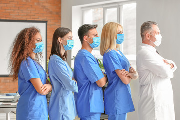 Wall Mural - Male lecturer with medical students in university