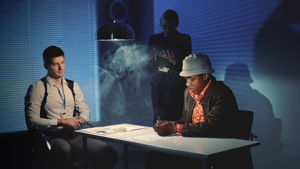 Wall Mural - Suspected mixed-race man signing a document of accusation. Interrogation room in smoke.