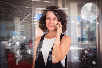 Woman speaking on cellphone and virtual identification graphics. Middle aged woman in casual calling on mobile phone in office hall. Phone talk concept