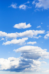 Wall Mural - low dark rainy clouds and white clouds in blue sky