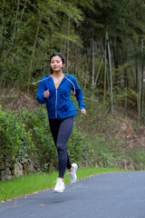 A young Asian female running outdoors