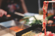 Hand use chopsticks fresh raw meat cooking or Sukiyaki