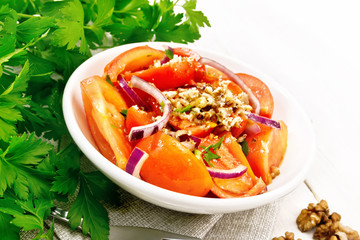 Poster - Salad with tomato and walnut in plate on light wooden board