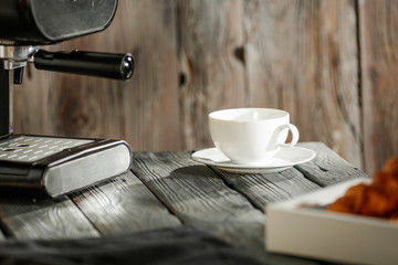 Wall Mural - Morning coffee on a wooden table in the light of the sun