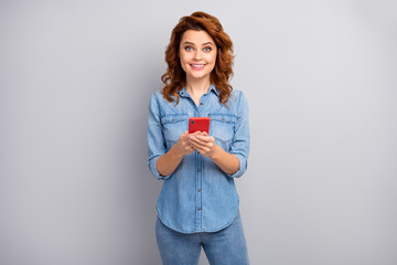 Portrait of excited positive cheerful woman use cellphone enjoy texting typing blog post wear good look outfit isolated over grey color background