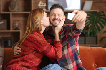 Poster - Happy couple taking selfie at home