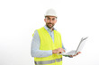 © W PRODUCTION - portrait of handsome foreman architect wearing yellow reflective vest and a hard hat using laptop studio shot isolated on white background