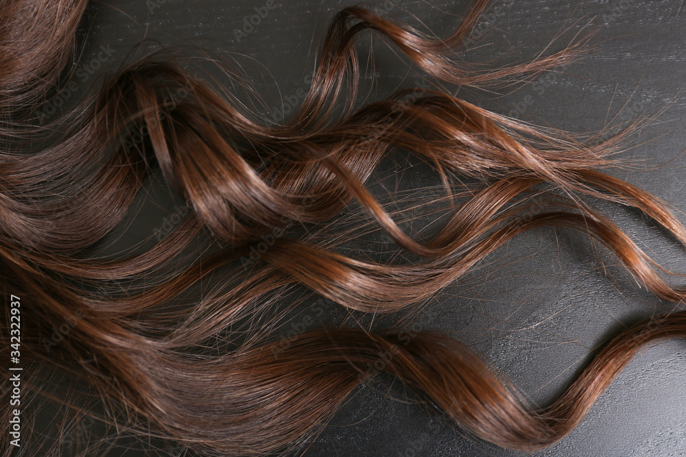 Curly female hair on dark background