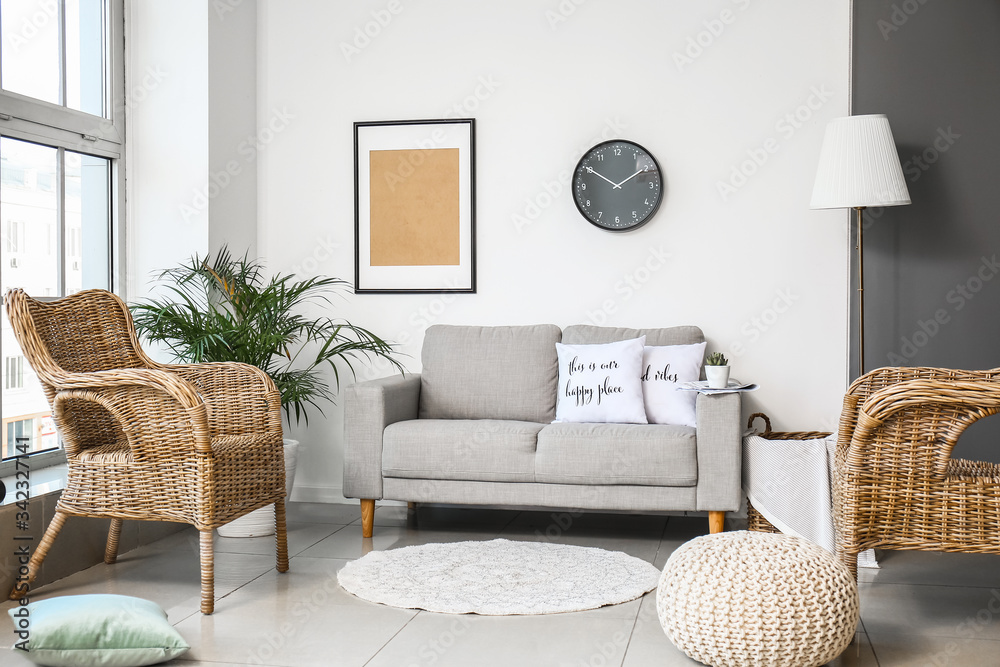 Interior of modern room with comfortable armchair and sofa