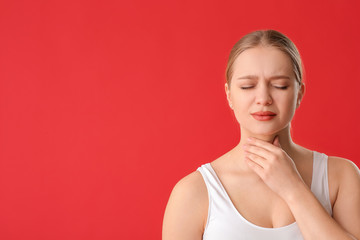 Poster - Young woman with thyroid gland problem on color background