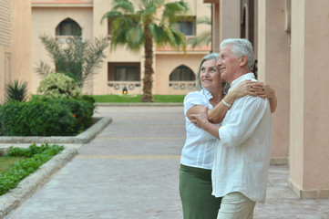 Canvas Print - Happy senior couple at hotel resort posing