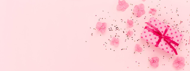 Wall Mural - Banner wuth Gift box, flowers and glitter confetti on pink background. Spring, summer Holidays, Birthday, Mothers Day. Copy space.