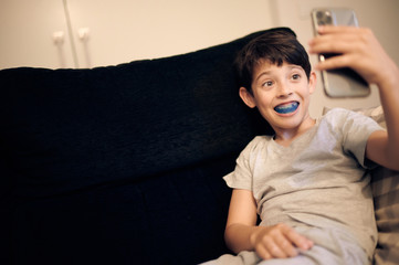 boy shows myofunctional trainer. Helps equalize the growing teeth and correct bite, develop mouth breathing habit. Corrects the position of the tongue.