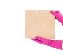 Close Up Hand In Pink Glove Hold Brown Clear Empty Blank Craft Paper Bag For Takeaway Isolated On White Background.