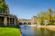 Landscape of the River Avon with Pulteney Bridge and the weir in the city of Bath, Somerset, UK on a clear and sunny Spring morning