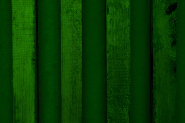 Green background of wooden sticks and concrete wall.