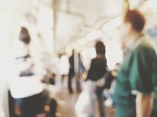 Blurred Image Of People Standing In Train