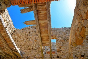 Wall Mural - Interior Close detail of ruins of abandoned house without roof  with stone bricks on empty beach near agrigento in Sicily Italy