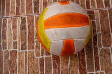 Dirty Volleyball Ball On The Garage Floor