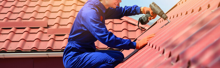 Wall Mural - Close up of young happy man contractor worker in blue overalls