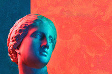 Statue Of Venus De Milo. Creative Concept Colorful Neon Image With Ancient Greek Sculpture Venus Or Aphrodite Head. Stucco Plaster Texture. Red And Blue Duotone Effects.