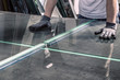 Leinwandbild Motiv glazier breaking glass on a professional table