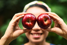 Close-up Of Woman Covering Eyes With Apples