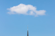 High Section Of Church Against White Cumulus In Blue Sky