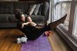 © Gerald Carter/Creative Flame - Smiling woman exercising with her son at home during quarantine