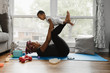 © Gerald Carter/Creative Flame - Happy Woman working out at home with baby during quarantine