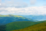 Fototapeta Na sufit - alpine scenery of carpathian mountains. stunning views on a windy summer day. clouds on the sky. ridges and valleys in the distance