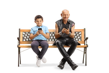 Poster - Boy and a punk sitting on a bench and typing on mobile phones