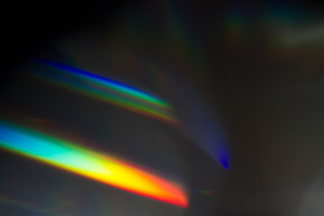 Fototapete - Sun reflection over a piece of crystal for a colorful lens flare on black background