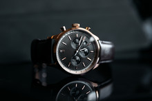 Gold LEATHER WATCH, VINTAGE STYLE WRIST WATCH, MEN'S LEATHER WATCH On Leather Background Blur.