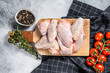 Raw chicken wings on cutting board, organic poultry meat. White background. Top view