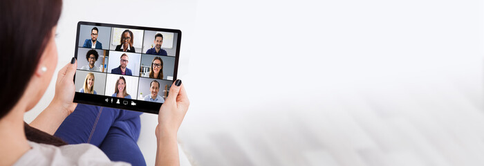 Wall Mural - Young Woman Using Tablet For Videochatting