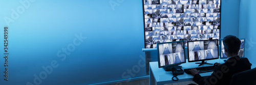 Fotomural Man In Control Room Monitoring Cctv Footage