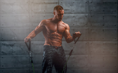 Wall Mural - Muscular Men Training With Resistance Bands