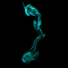 Close-up Of Green Smoke Against Blue Background