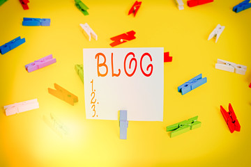 Poster - Word writing text Blog. Business photo showcasing regularly updated website web page run by individual Colored clothespin papers empty reminder yellow floor background office