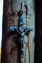 Close-up Of Cross With Jesus Christ On Wooden Post