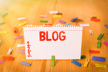 Poster - Conceptual hand writing showing Blog. Concept meaning regularly updated website web page run by individual Colored crumpled papers wooden floor background clothespin