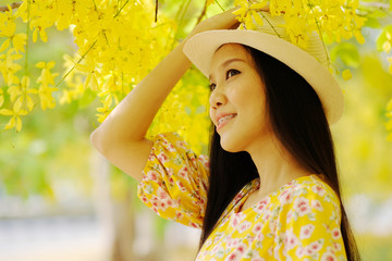 Wall Mural - portrait of beautiful woman in yellow dress with summertime