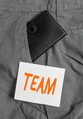 Poster - Word writing text Team. Business photo showcasing Group of showing working together Classed and share certain beliefs Small little wallet inside man trousers front pocket near notation paper