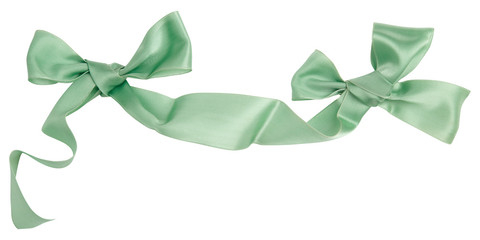 Wall Mural - Green ribbon curl isolated on white background. Bright green ribbon bow and curl isolated on white background. Textile accessories for sewing and gift scrapbooking decorations. Atlas or silk ribbon