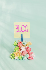 Poster - Handwriting text writing Blog. Conceptual photo regularly updated website web page run by individual Reminder pile colored crumpled paper clothespin reminder blue background