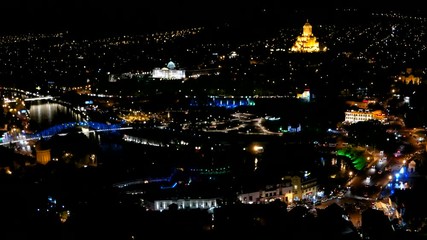 Wall Mural - Night panorama view of Tbilisi capital of Georgia country. Metekhi church Holy Trinity Cathedral Sameba and Presidential Administration at night with illumination and moving cars